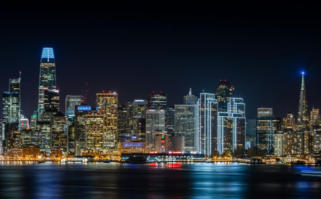 Stunning view of San Francisco's skyline with illuminated skyscrapers, captured at night.